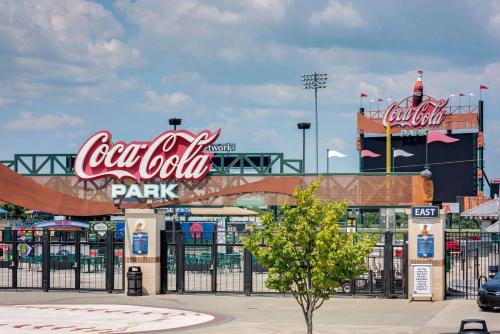 a park with cocacola signs and a parking lot at Super 8 by Wyndham Allentown in Allentown