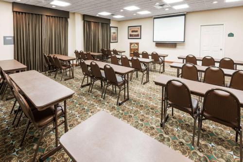 a classroom with tables and chairs and a screen at Wingate by Wyndham New Braunfels in New Braunfels