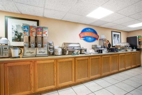 a fast food restaurant with a counter with food at Baymont by Wyndham Hays in Hays