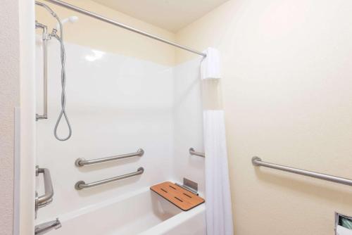 a bathroom with a shower and a toilet at Super 8 by Wyndham St Robert Ft Leonard Wood Area in Saint Robert