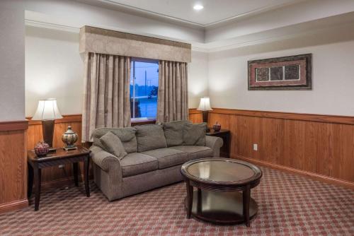 a living room with a couch and a table at Super 8 by Wyndham St Robert Ft Leonard Wood Area in Saint Robert