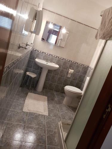 a bathroom with a sink and a toilet at Side Seaview St Pauls Bay Apartment in St. Paul's Bay