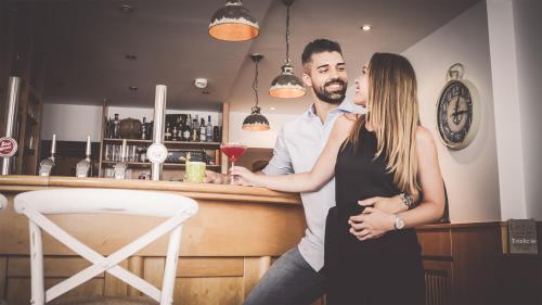 a man and a woman standing at a bar at Landhotel Stegersbach in Stegersbach