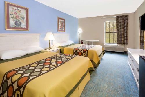 a hotel room with two beds and a window at Super 8 by Wyndham Freeport in Freeport