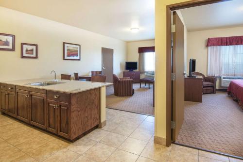a room with a kitchen and a living room at Days Inn by Wyndham Ellis in Ellis