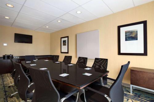 a conference room with a black table and chairs at Wingate by Wyndham Seminole in Seminole