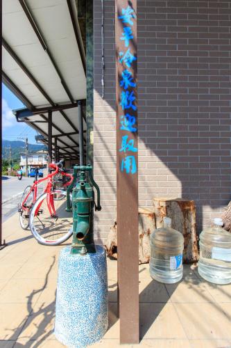 a green fire hydrant on the side of a building at Yilan Dongshan Cypress B&B in Dongshan
