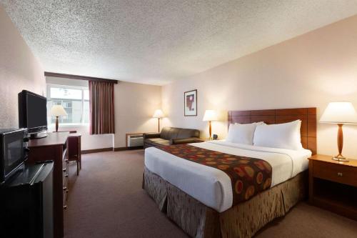 A bed or beds in a room at Ramada by Wyndham Bismarck