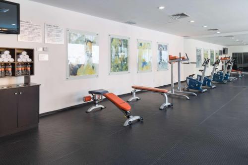a gym with a row of exercise equipment on the wall at HS HOTSSON Smart León Centro Max in León