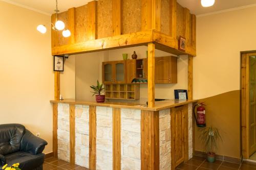 a large wooden bar in a living room at Bakterház Vendégház in Nagyvisnyó