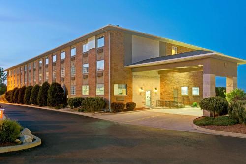 a large brick building with a road in front of it at Super 8 by Wyndham Gurnee in Gurnee