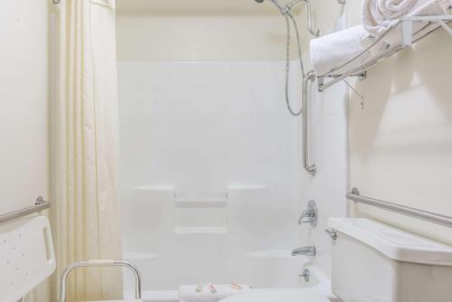 a white bathroom with a toilet and a sink at Super 8 by Wyndham Clovis in Clovis