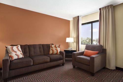 a living room with a couch and a chair at Super 8 by Wyndham Carbondale in Carbondale