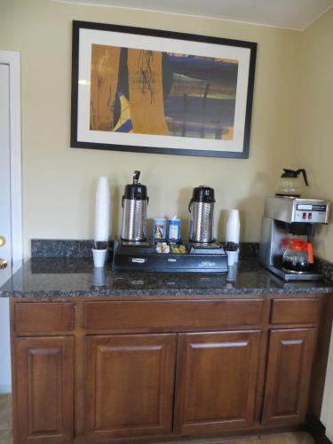 a kitchen with a counter top with a coffee maker at American Inn and Suites in Countryside