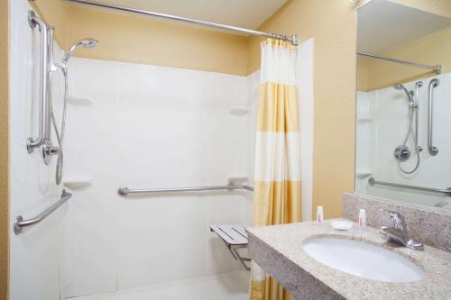 a bathroom with a sink and a shower at Baymont by Wyndham Madison Heights Detroit Area in Madison Heights