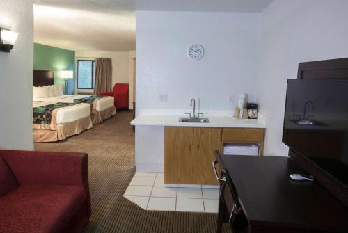 a hotel room with a sink and a room with a bed at Baymont by Wyndham Keystone Near Mt. Rushmore in Keystone