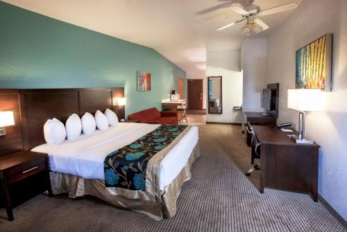a hotel room with a large bed and a desk at Baymont by Wyndham Keystone Near Mt. Rushmore in Keystone