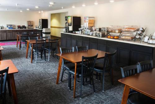 a dining room with tables and a counter at Baymont by Wyndham Keystone Near Mt. Rushmore in Keystone