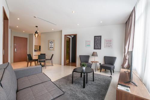 a living room with a couch and a table at The Penthouse KLCC in Kuala Lumpur