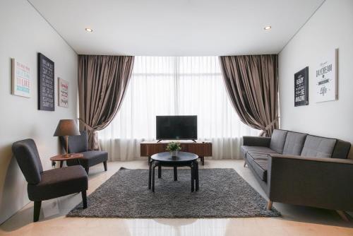 a living room with a couch and a table at The Penthouse KLCC in Kuala Lumpur