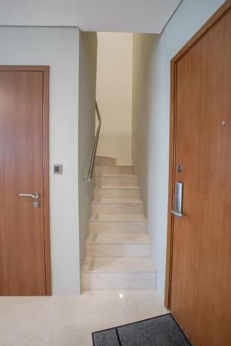 a hallway with a staircase with a wooden door at The Penthouse KLCC in Kuala Lumpur