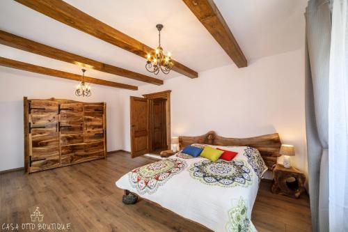 a bedroom with a bed and wooden ceilings at Casa Otto Sighisoara in Sighişoara