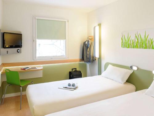Ένα ή περισσότερα κρεβάτια σε δωμάτιο στο ibis budget Metz Sud