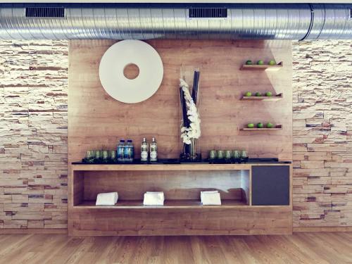 a room with a wall with a shelf and a stone wall at Mercure Tagungs- & Landhotel Krefeld in Krefeld