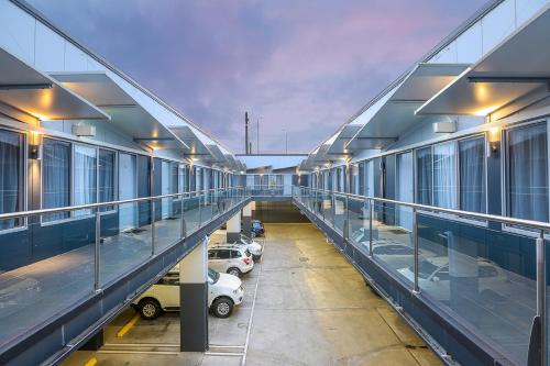 an empty hallway of a building with parked cars at Belmercer Motel in Geelong