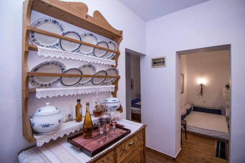 a room with a counter with plates and bottles on it at Dreaming House in Nea Vrasna