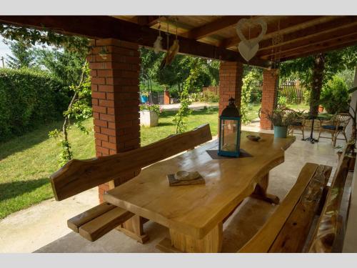 a wooden table and benches on a patio at Villa Palma Karojba in Karojba