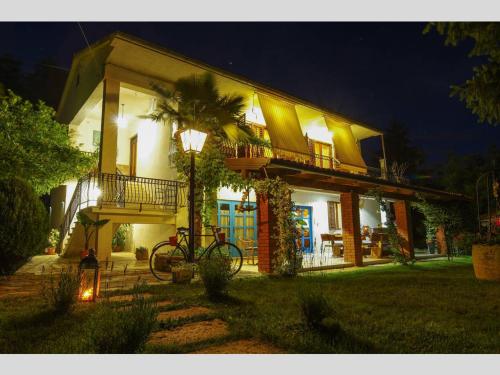 a house with a bike parked in front of it at night at Villa Palma Karojba in Karojba