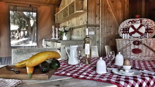 a table with a squash and vegetables on a cutting board at Le Lodge du Domaine Saint Martin in Flassans-sur-Issole