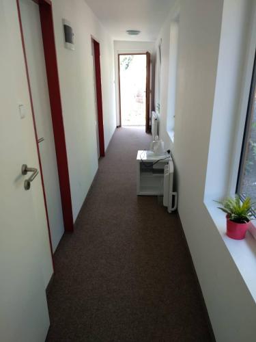 a hallway of an office with a door and a desk at Rodinné vinařství Mikulenkovi in Žernoseky