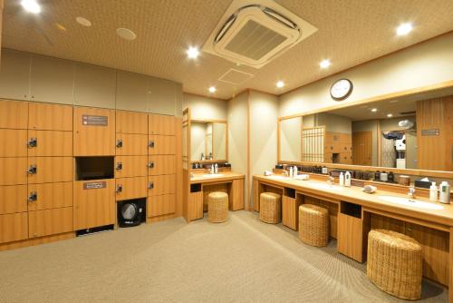 a large bathroom with two sinks and a large mirror at Dormy Inn Takamatsu Chuo Koenmae Natural Hot Spring in Takamatsu