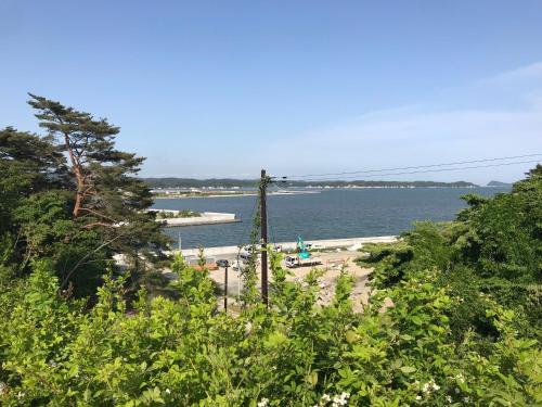 a view of a beach with a body of water at Luxury ocean front house Bay-villa in Matsushima