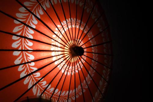 a red umbrella with a white pattern on it at Dormy Inn Takamatsu Chuo Koenmae Natural Hot Spring in Takamatsu