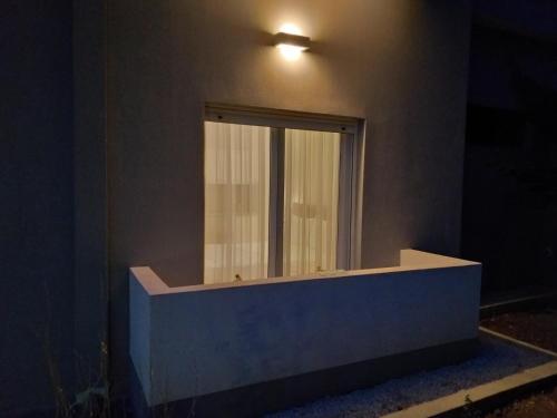 a mirror on the side of a building with a window at Rustemi in Sarandë