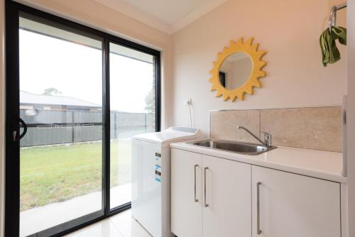 a kitchen with a sink and a large window at Euphoria House in Wynyard