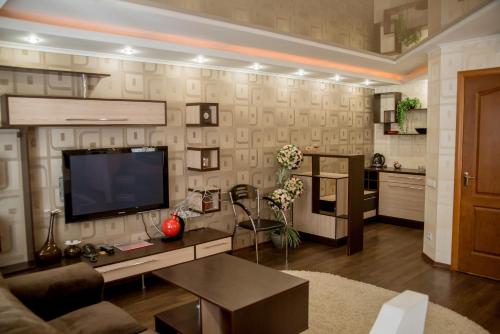 a living room with a flat screen tv on a wall at Dniprovski Zori in Kremenchuk