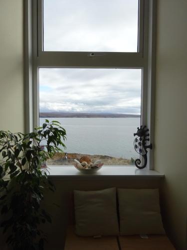 a window with a view of the water at Gairloch Sands Youth Hostel in Gairloch