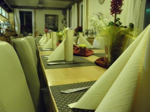 a long table with white napkins on it at Alb Hotel Schalksburg in Albstadt