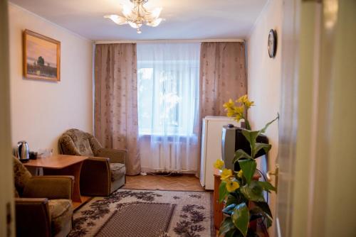 a living room with a table and a window at Dniprovski Zori in Kremenchuk