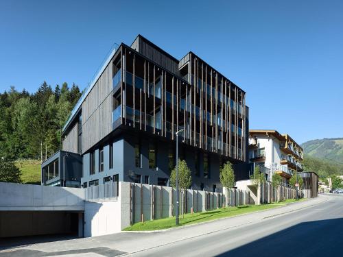 a black building on the side of a street at Hotel Der Waldhof in Zell am See