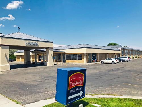 a store with a sign in front of a parking lot at FairBridge Extended Stay, a Kitchenette Hotel in Idaho Falls