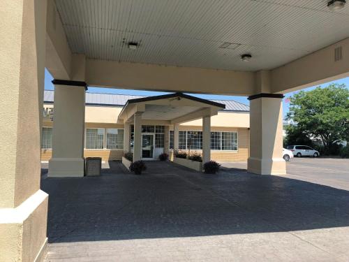 a large building with columns in a parking lot at FairBridge Extended Stay, a Kitchenette Hotel in Idaho Falls