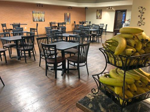 a restaurant with tables and chairs with bananas on display at FairBridge Extended Stay, a Kitchenette Hotel in Idaho Falls