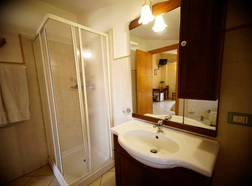 a bathroom with a shower and a sink and a mirror at B&B Casalotto Inn in Aci SantʼAntonio