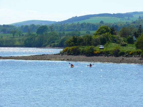 two people in the water on a river at Kiltearn Guest House in Evanton