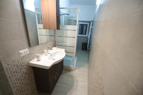 a bathroom with a sink and a mirror at Dimora Civitas Severiana in Montescaglioso